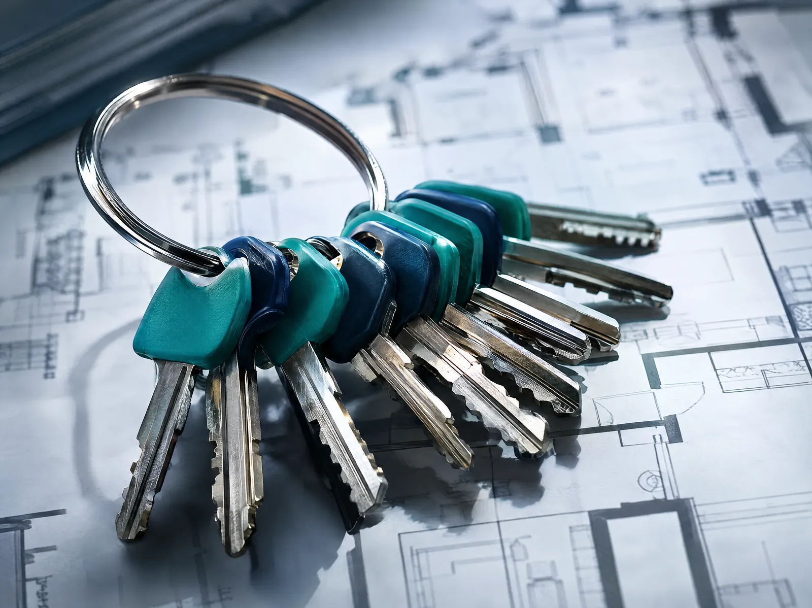 Colour-coded master keys on a ring over a floor plan